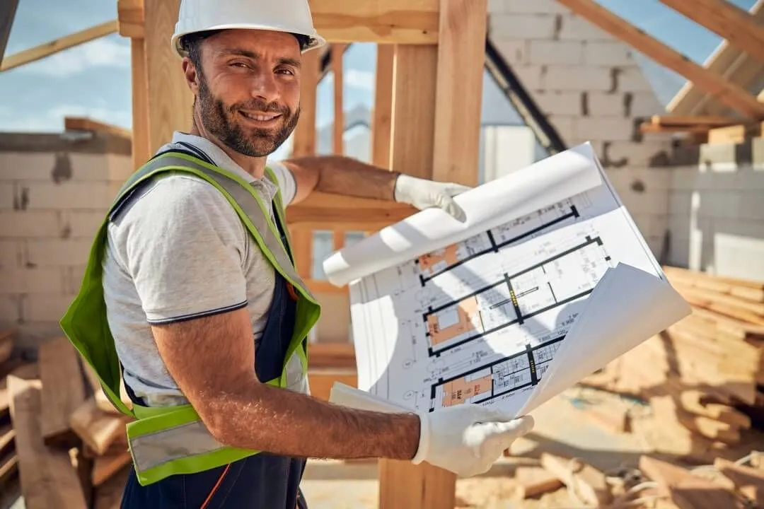 stock image of foreman looking at blueprintts